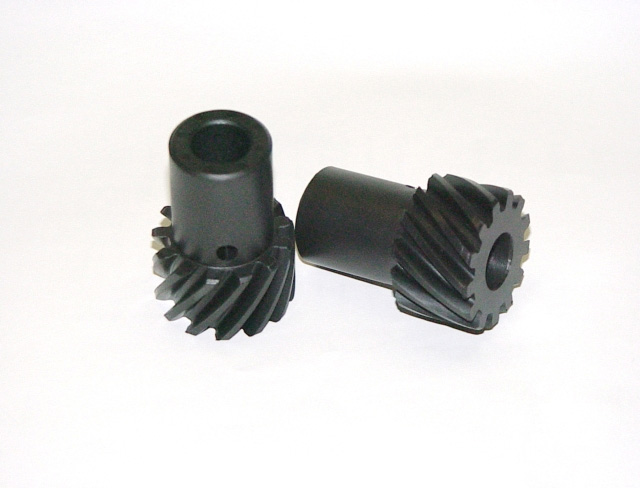 Two black helical gears on a white background