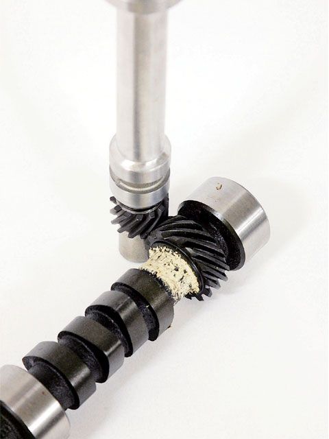 1990 Ford Bronco - Close-up of a camshaft and distributor gear, showing wear on the camshaft's gear.