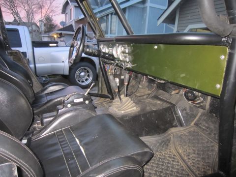 1974 Ford Bronco - Interior view of a modified vehicle, with a pickup truck visible through the window.