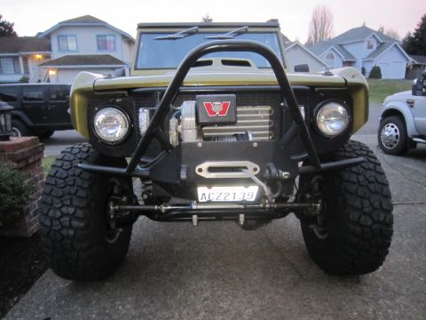 1974 Ford Bronco - This heavily modified SUV features oversized tires and a prominent winch mounted on the front bumper. The license plate is ACZ2139.