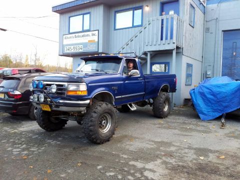 1990 Chevrolet Suburban - This lifted 1992 Ford F-250 pickup truck is parked outside a building with a sign for Alison's Relocations, Inc.