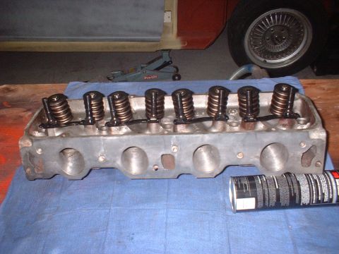 1969 Ford Torino - Engine cylinder head with valves and springs, next to a can of spray lubricant.
