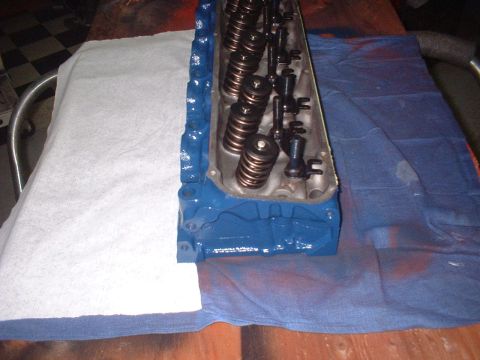 1969 Ford Torino - A freshly painted engine cylinder head sits on a table, ready for reassembly.