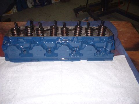 1969 Ford Torino - A blue painted engine cylinder head is shown with its internal valve components.