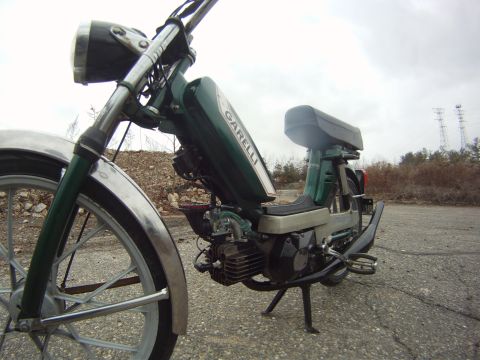 1981 Garelli Rally Sport - A green moped is shown from the side, with the 'Garelli' logo visible on its fuel tank.