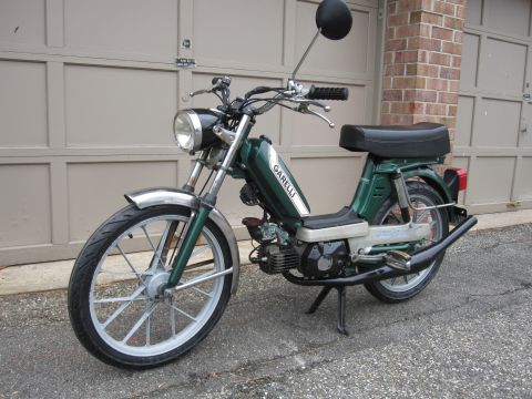 1981 Garelli Rally Sport - Green moped with 'GARELLI' text on the tank is parked in front of a garage.
