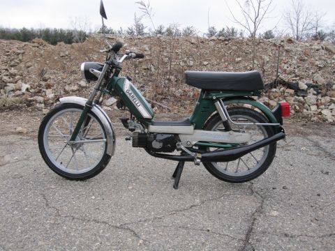1981 Garelli Rally Sport - This green moped features chrome fenders and exhaust, with 'GARELLI' branding visible on the fuel tank.