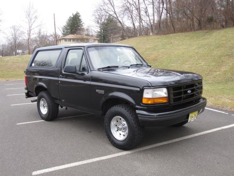 1996 Ford Bronco - This black 1996 Ford Bronco is shown from a three-quarter front view in a parking lot.