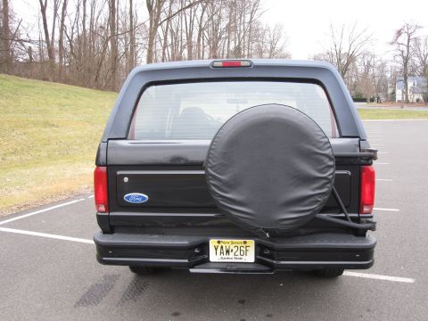 1996 Ford Bronco - The rear of a black Ford Bronco is shown, a spare tire and a New Jersey license plate.