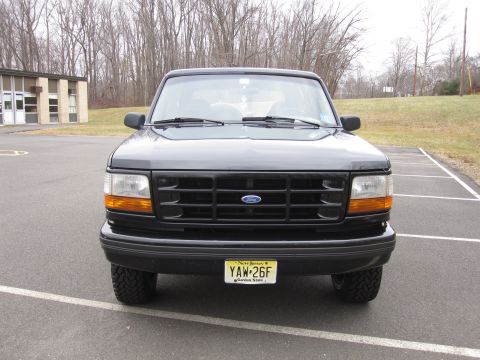 1996 Ford Bronco - Front view of a black Ford Bronco, parked in an outdoor lot.