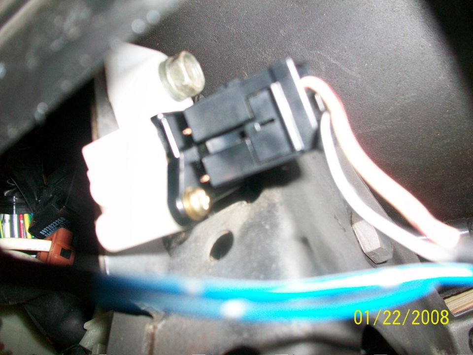 Electrical connector with white and beige wires attached to a white plastic housing, bolted to a metal bracket. Date stamp 01/22/2008