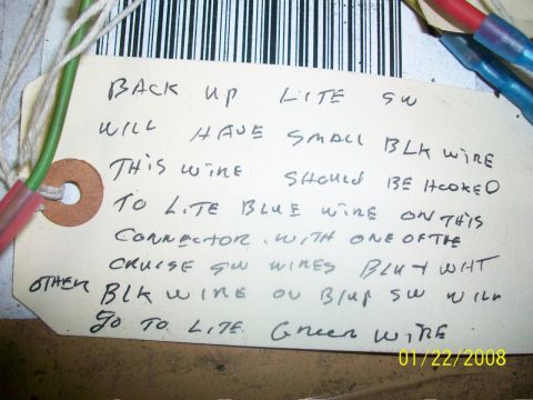 2000 Isuzu Vehicross - A handwritten tag details wiring connections for a backup light switch and cruise control switch, with wires attached.