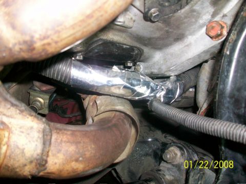 2000 Isuzu Vehicross - Close-up view of engine compartment components, including exhaust and wiring, with a date stamp.