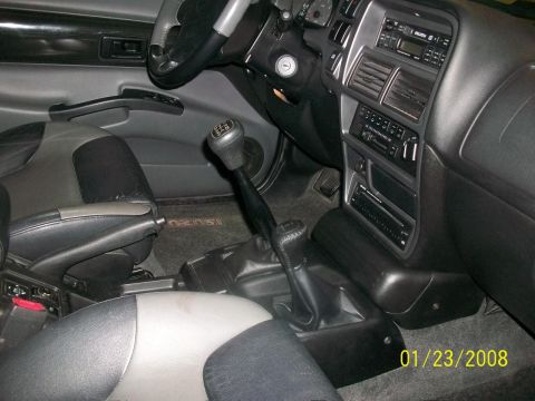 2000 Isuzu Vehicross - Interior view of a vehicle's dashboard and seats, showing a manual transmission and floor mat with Isuzu branding.