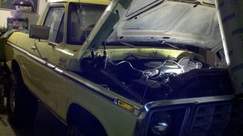 1978 Ford Bronco - This yellow Ford truck, likely from the 1970s, has its hood open for engine access.