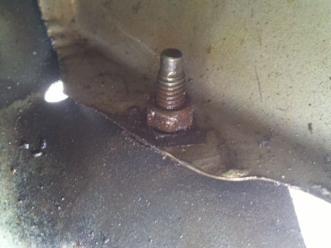 1978 Ford Bronco - A close-up view of a bolt and nut, likely part of a vehicle's undercarriage or engine bay.