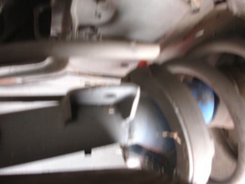 1993 Ford Taurus - Underside view of a vehicle's suspension system, showing a shock absorber and coil spring.
