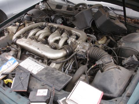 1993 Ford Taurus - The engine bay of a 1993 Ford Taurus SHO is visible, the 3.0L V6 engine.