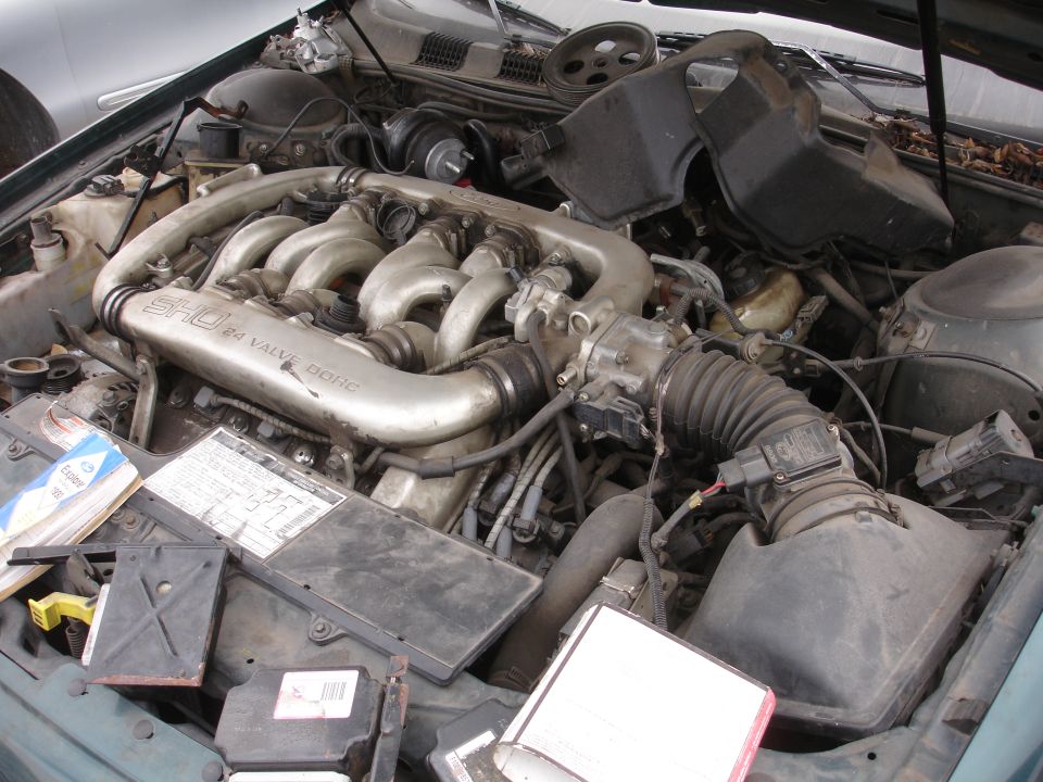 Engine bay of a 1993 Ford Taurus SHO, showing the 3.0L V6 engine with SHO 24 VALVE DOHC intake manifold