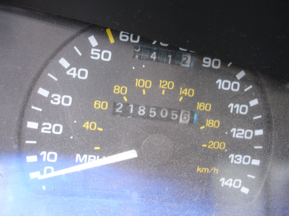 Car odometer showing 218505 miles and 412 miles on trip meter