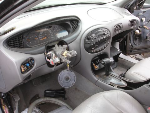 1993 Ford Taurus - The interior of a 1993 Ford Taurus shows a disassembled steering column and dashboard, with visible wiring and components.