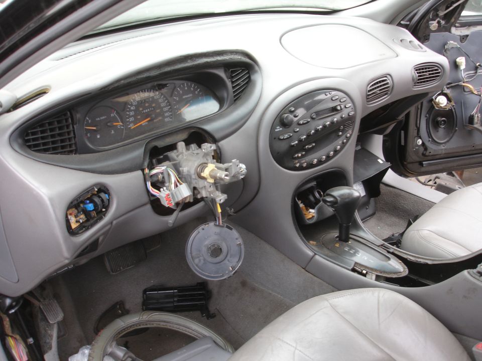 1993 Ford Taurus interior with disassembled steering column and dashboard