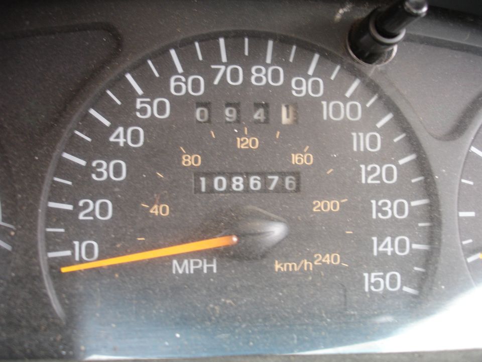 Car speedometer showing 0-150 MPH and 108,676 miles