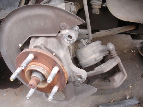1993 Ford Taurus - Front brake assembly showing rotor, caliper, and dust shield.