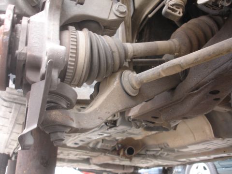 1993 Ford Taurus - Underside view of a vehicle's front suspension system, highlighting the drive axle and control arm.