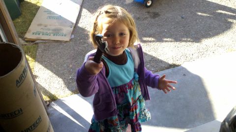 1978 Ford Bronco - Child holds a wrench, ready to help with motor rebuild.