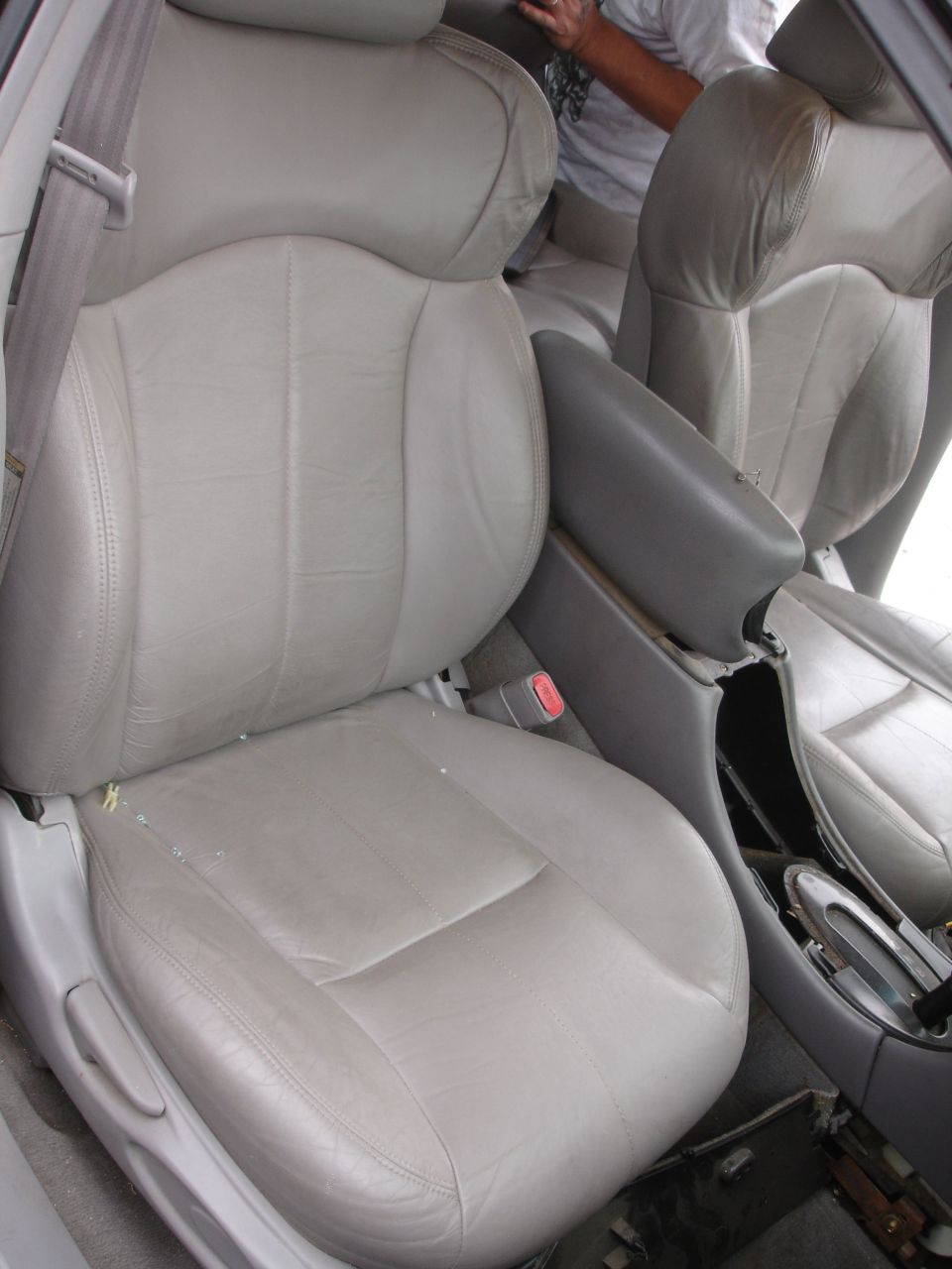 Interior car seats, light gray leather, center console visible