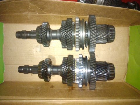 1993 Ford Probe - Two automotive transmission shafts, each with several gears, are shown side-by-side in a box.