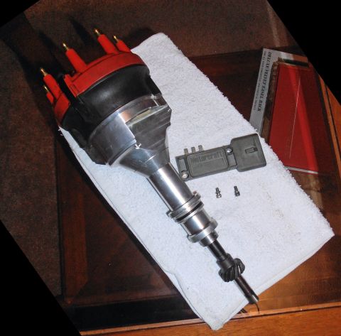 1990 Ford Bronco - A disassembled Ford distributor and ignition control module are laid out on a towel.