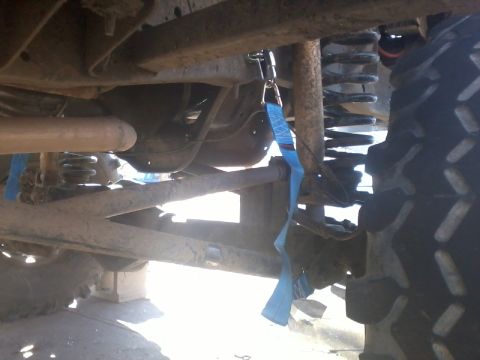 1986 Ford Bronco - Close-up of vehicle undercarriage with a blue strap attached to the frame.