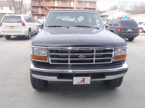 1994 Ford Bronco - This 1994 Ford Bronco is shown from the front, its distinctive chrome grille and an Alabama collegiate license plate.
