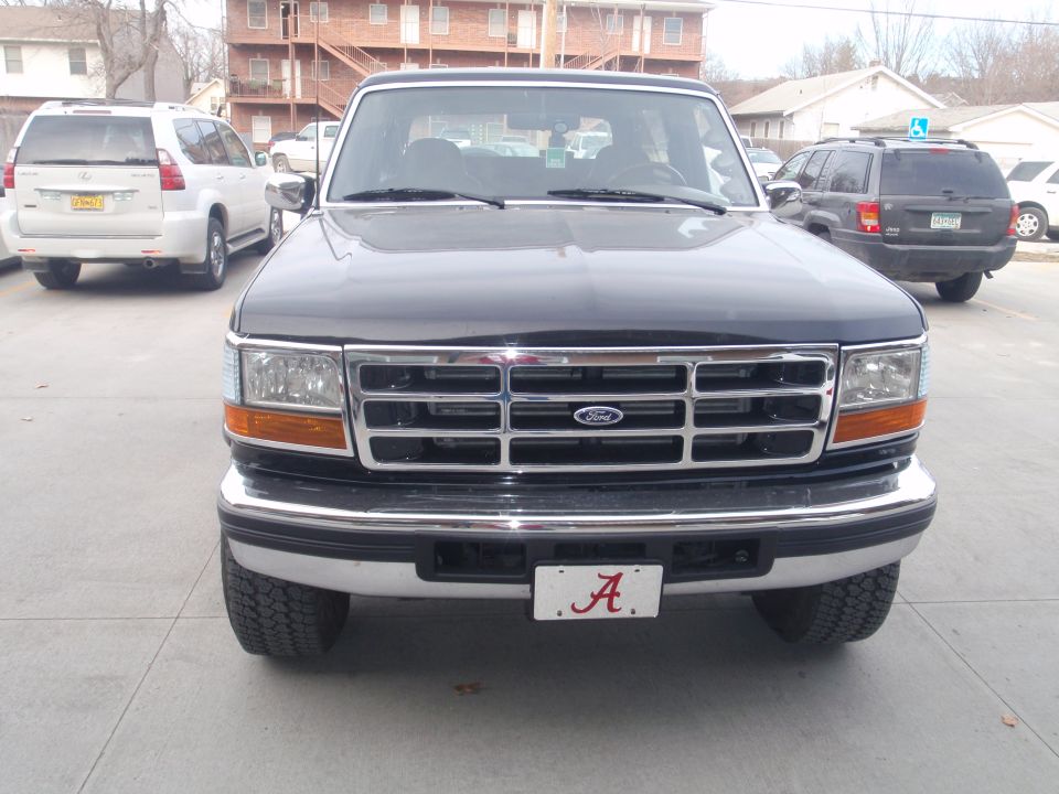 Front view of black 1994 Ford Bronco with chrome grille and Alabama license plate
