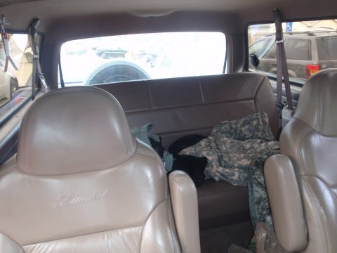 1994 Ford Bronco - Interior of a 1994 Ford Bronco Limited, with camouflage gear on the back seat.