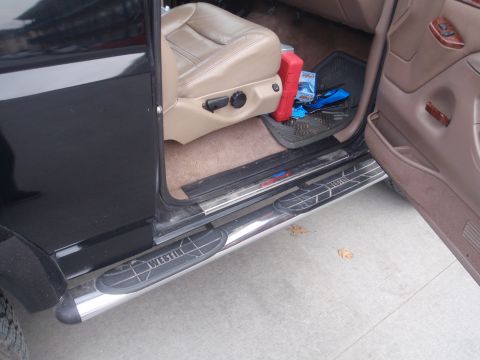 1994 Ford Bronco - View of the interior from the driver's side, highlighting the running boards and seat.