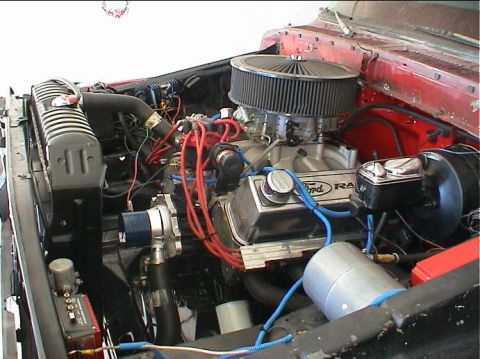 1979 Ford Bronco - Close-up view of a modified engine bay, showing various components and wiring.