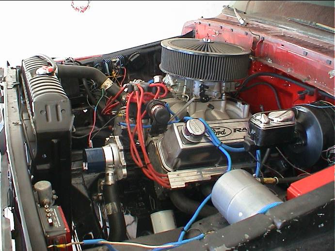 Red truck engine bay with Ford Racing V8, chrome air cleaner and red plug wires