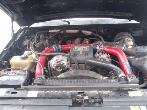 1994 Ford Bronco - Engine bay view shows a "Power Stroke Turbo 444" engine with prominent red intercooler piping.