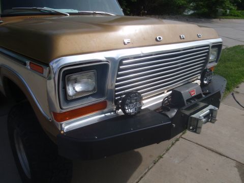 1978 Ford Bronco - Front view of a 1978 Ford Bronco, a chrome grille and a winch bumper.