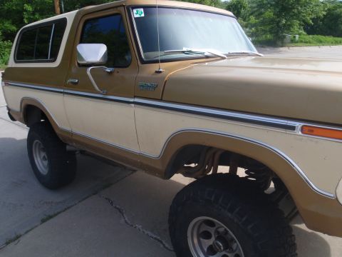 1978 Ford Bronco - This two-tone Ford Bronco is shown from the front three-quarter view, highlighting its lifted suspension and classic body style.