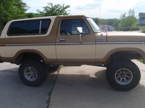 1978 Ford Bronco - This two-tone brown 1978 Ford Bronco is shown from the side, lifted with off-road tires.