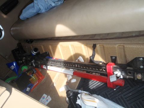 1978 Ford Bronco - A Hi-Lift jack and various items are stored in the cargo area of a vehicle.