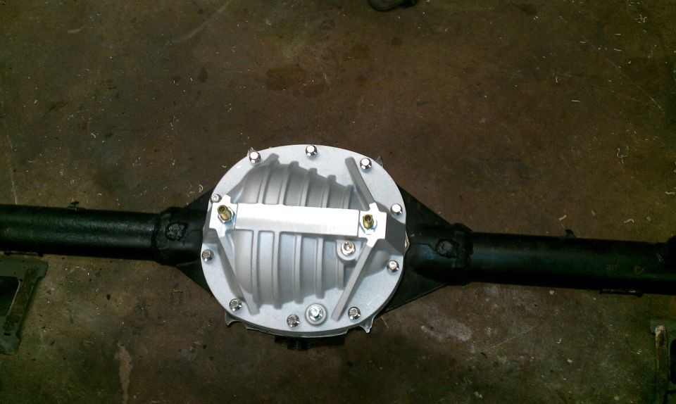 Rear differential assembly with a silver cover and black axle tubes