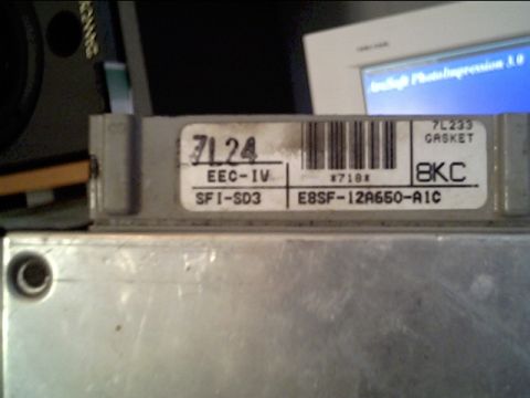 1991 Ford LTD Crown Victoria - Close-up of the ID label on a Ford EEC-IV engine control computer, reading SFI-SD3, part number E8SF-12A650-A1C, strategy code 8KC and hand…