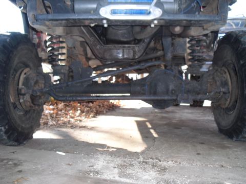 1986 Ford Bronco - This image shows the undercarriage of a 4x4 vehicle, focusing on the suspension and drivetrain components.