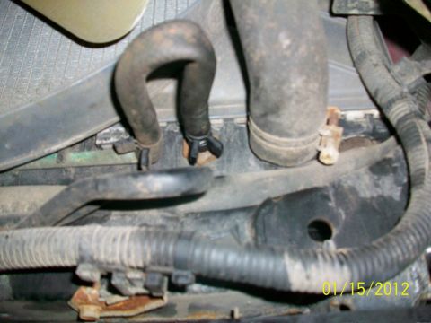 2000 Isuzu Vehicross - The image shows a close-up view of engine hoses and parts of a radiator, with a date stamp from 2012.