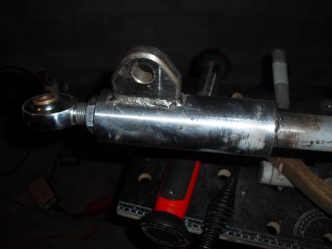 1986 Ford Bronco - Close-up of a metal rod with a spherical joint and a welded bracket, likely a vehicle suspension component.
